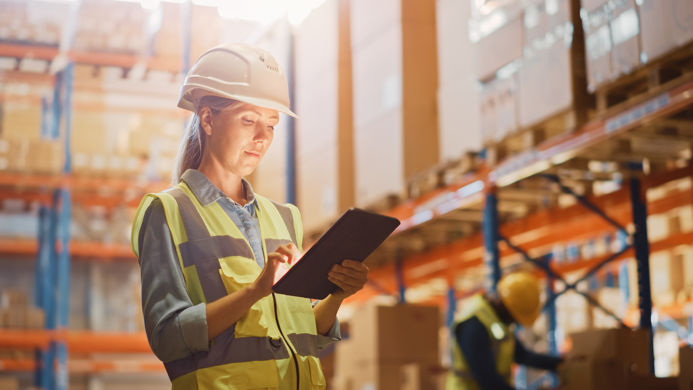 Professional Female Worker in Warehouse Checking Stock for IT Moving Services